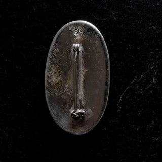 Reserved Grace vintage Navajo sterling silver pin back showing SR signature and sterling stamp on black background