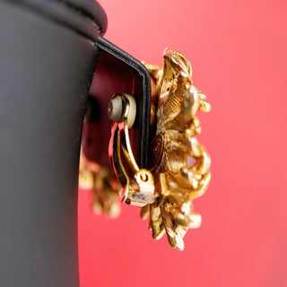 Reserved Grace Oscar de la Renta gold-tone floral clip-on earring side view showing secure metal clasp mechanism
