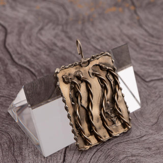Reserved Grace hand-stamped rectangular silver pendant featuring twisted wire details and a signed artisan finish.