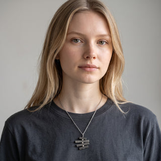 Reserved Grace vintage sterling silver articulated bar pendant necklace on an 18-inch chain worn by a woman.