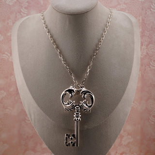 Reserved Grace vintage sterling silver Rococo key pendant on a long Italian 925 chain displayed on a jewelry bust.