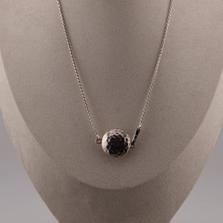 Reserved Grace 16-inch sterling silver Saturn chain necklace featuring a textured hammered round pendant on a display.