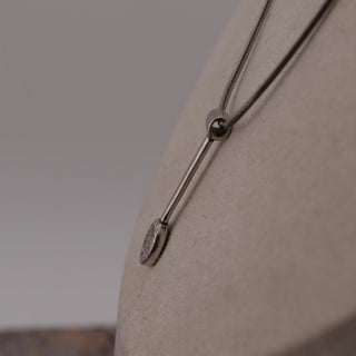 Reserved Grace tiny sterling silver spoon pendant on a 17-inch 925 silver chain displayed on a necklace bust