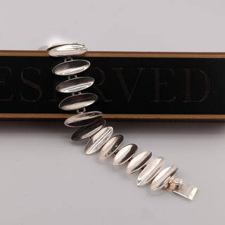 Reserved Grace vintage Taxco Mexican Modernist sterling silver link bracelet with polished convex oval sunburst links.