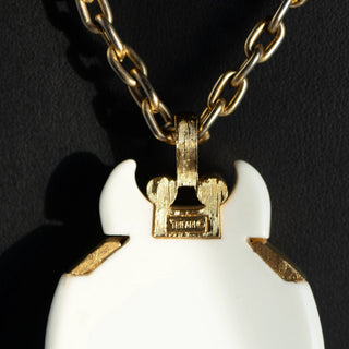 Reserved Grace vintage Crown Trifari beetle pendant necklace featuring a white lucite body and gold-tone metal frame.