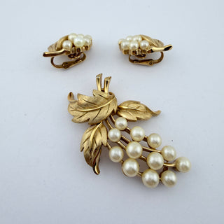 Reserved Grace vintage Trifari brooch and clip-on earring set featuring textured gold-tone leaves and faux pearl grapes.