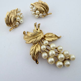 Reserved Grace vintage Trifari brooch and clip-on earring set featuring gold-tone textured leaves and faux pearl grapes.