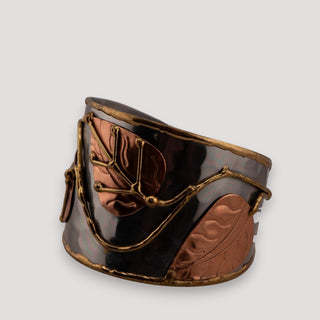 Reserved Grace Anju tri-tone cuff bracelet featuring copper, brass, and silver leaf appliqués on a dark metal band.