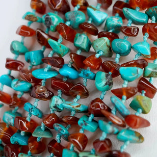 Reserved Grace 8-strand turquoise and carnelian chip bead necklace with blue thread knotting in a close-up view