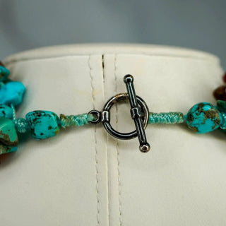 Reserved Grace 8-strand turquoise and carnelian chip necklace featuring a sterling silver toggle clasp on a display