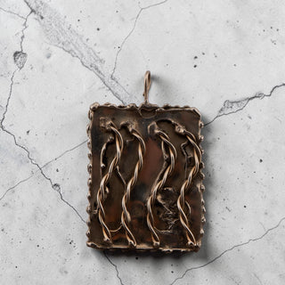 Reserved Grace hand-stamped rectangular silver pendant with twisted wire accents and textured edges.