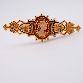 Reserved Grace vintage goldtone bar pin featuring a detailed resin cameo in a romantic, ornate metal frame.