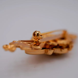 Reserved Grace vintage goldtone bar pin featuring a detailed resin cameo, shown from a side angle with a secure clasp.