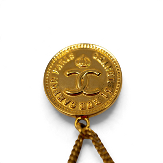Reserved Grace vintage Chanel gold-tone brooch featuring a 31 Rue Cambon coin medallion and dangling handbag charm.