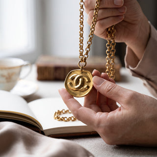 Reserved Grace vintage gold-plated Chanel CC logo medallion necklace with a textured finish and belcher chain.