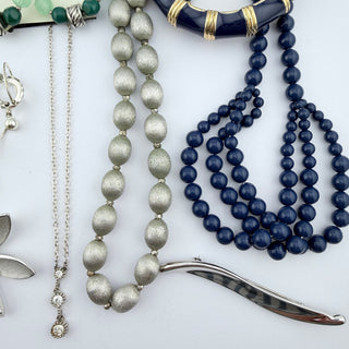 Reserved Grace vintage-inspired costume jewelry collection featuring silver-tone chains, navy-blue beads, and bangles.