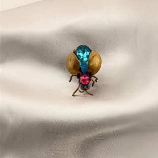 Reserved Grace vintage Czech bug brooch featuring a blue teardrop stone, pink rhinestone, and metallic gold finish.