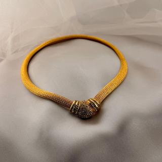 Reserved Grace vintage Christian Dior gold mesh collar necklace with a central Art Deco style clasp on white fabric.