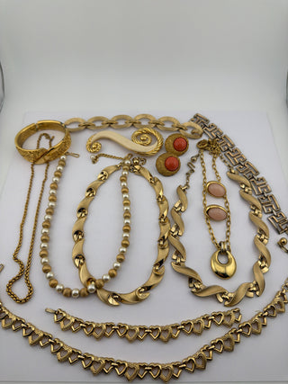 Reserved Grace vintage gold-tone jewelry collection featuring pearl necklaces, heart-link chains, and coral earrings.