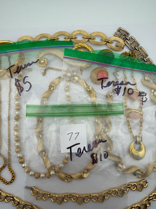 Reserved Grace vintage gold-tone jewelry collection including pearl necklaces, heart-link chains, and statement brooches