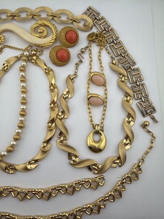 Reserved Grace vintage gold-tone jewelry collection featuring necklaces, pearl accents, coral earrings, and heart chains.