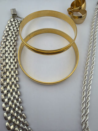 Reserved Grace vintage jewelry set with gold-tone bangles, silver-tone link bracelet, rope necklace, and clip earrings.