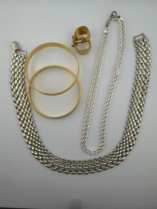Reserved Grace vintage-inspired jewelry set featuring silver-tone link necklace, rope chain, bangles, and gold earrings.