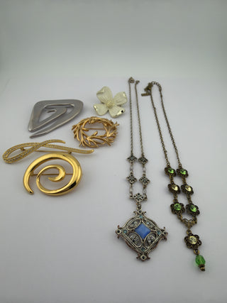 Reserved Grace vintage jewelry collection featuring assorted gold, silver, and enamel brooches and crystal necklaces.