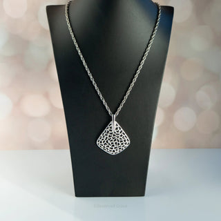 Reserved Grace vintage Crown Trifari silver tone leopard spot cutout pendant necklace on a black display stand