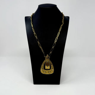 Reserved Grace vintage 1970s Monet gold-tone link necklace featuring a textured belt buckle pendant on a display bust.