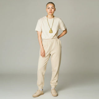Reserved Grace vintage 1970s Monet gold-tone belt buckle pendant necklace worn by a model in a beige outfit