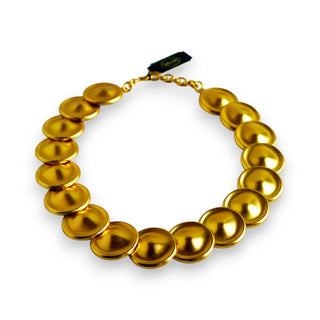 Reserved Grace vintage Monet gold-tone necklace featuring a sequence of matte circular disks on a linked chain.