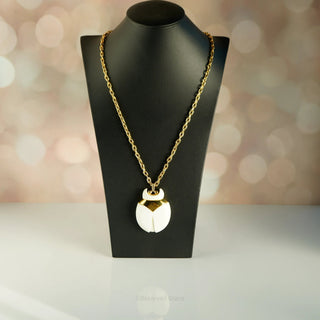 Reserved Grace vintage Crown Trifari beetle pendant necklace featuring a white lucite body and gold-tone metal frame.