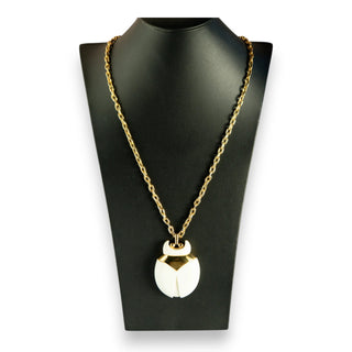 Reserved Grace vintage Crown Trifari beetle pendant necklace with white lucite and gold-tone metal on a display bust
