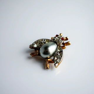 Reserved Grace vintage Trifari insect brooch with a silver-gray cabochon body and sparkling rhinestone accents.
