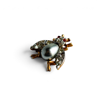 Reserved Grace vintage Trifari insect brooch with a silver-gray cabochon body and sparkling rhinestone accents.