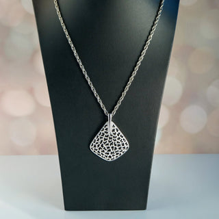 Reserved Grace vintage Crown Trifari silver-tone pendant necklace featuring a mod leopard spot cutout design.