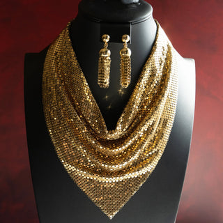 Reserved Grace vintage Whiting & Davis gold mesh necklace and tassel clip earring set on a black display bust.