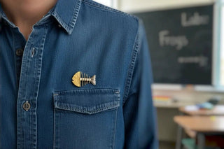 Reserved Grace modernist fishbone brooch in mixed gold and silver metal with a secure clasp.