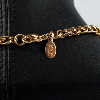 Reserved Grace vintage Nolan Miller necklace featuring a gold-tone chain with a signature designer logo tag