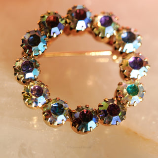 Multicolored gemstone bracelet on a light pink background